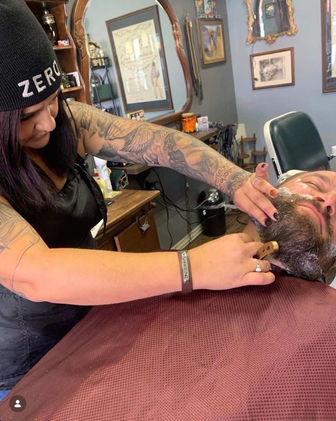 Elizabeth providing a straight razor shave at Truly Blessed Barber Studio